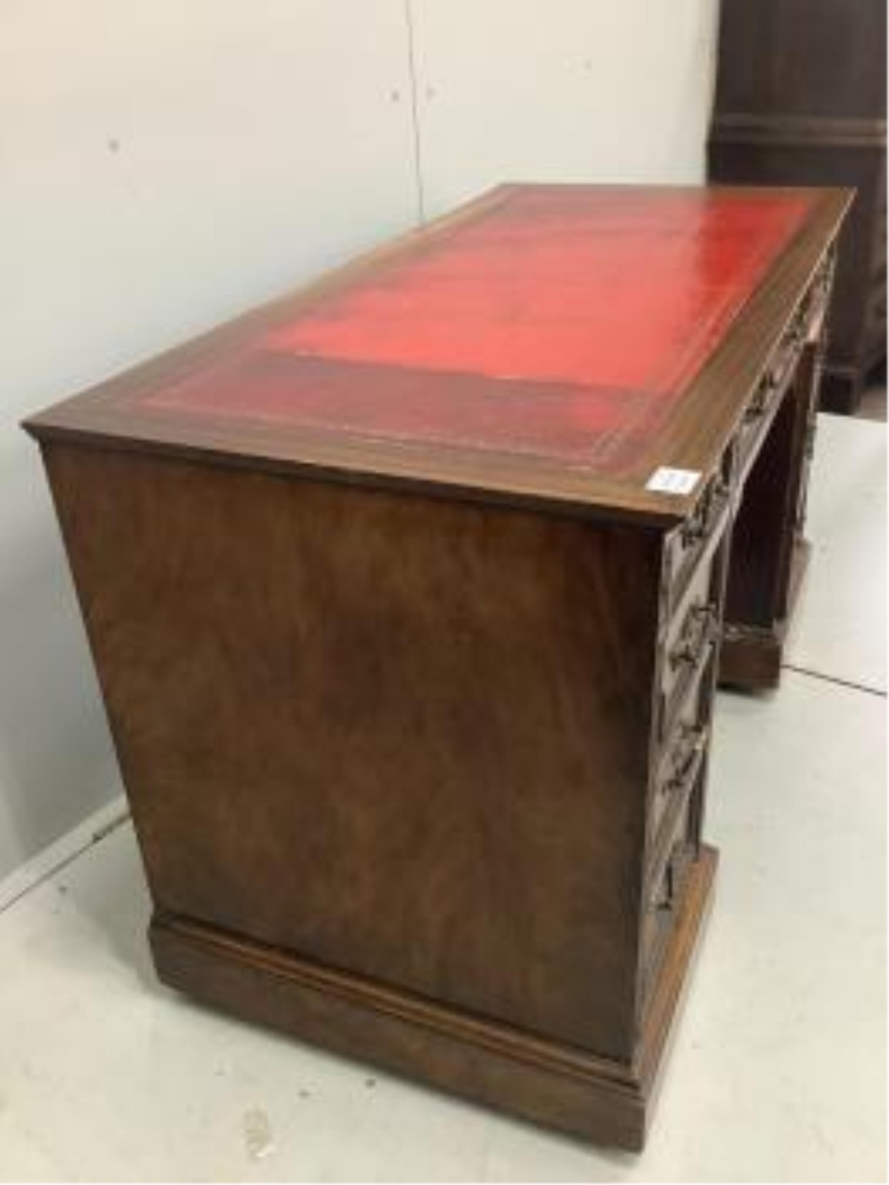 An Edwardian mahogany pedestal desk, pedestals with dummy front drawers, width 121cm, depth 59cm, height 73cm. Condition - fair to good